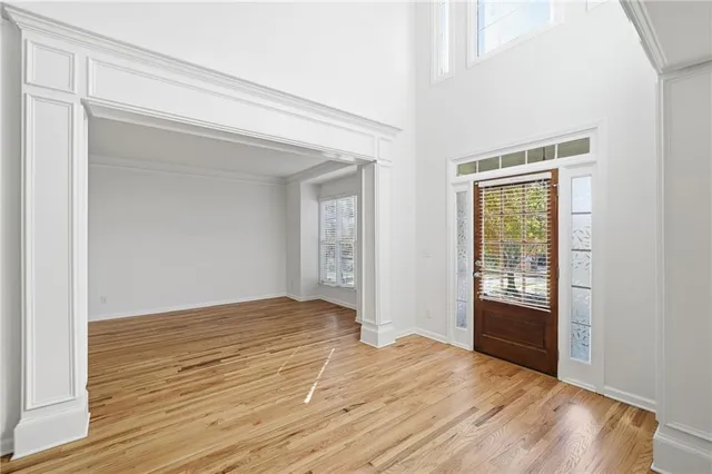 wooden floor in an empty room with a window