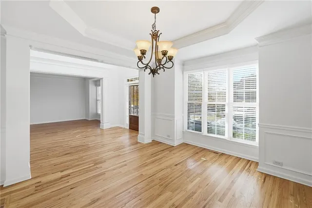 a view of an empty room with fireplace and wooden floor