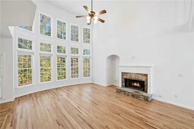 a view of an entryway wooden floor and a kitchen
