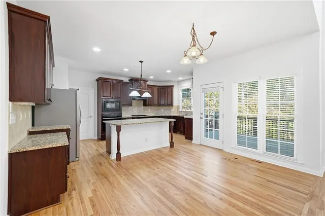 a kitchen with granite countertop cabinets sink and window