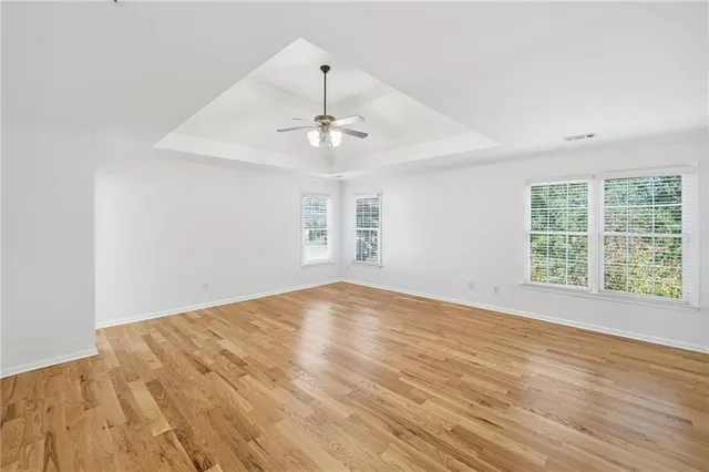 a spacious bathroom with a granite countertop double vanity and a mirror