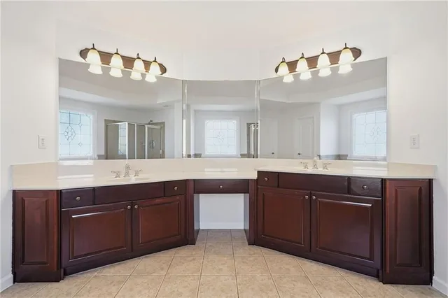 a bathroom with a toilet a sink a mirror and a bathtub