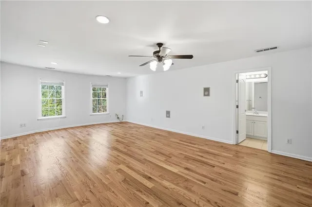 a view of a backyard with plants and a bench