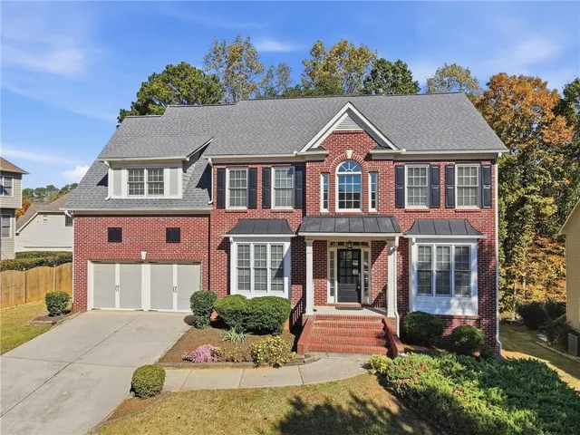 aerial view of a house with a yard and garden