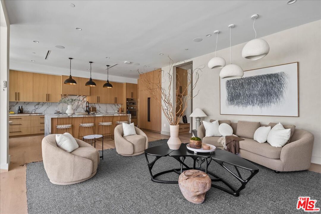 11317 Valley Spring Lane Studio City, CA 91602 - Photo 12 of 40 a living room with furniture and a kitchen