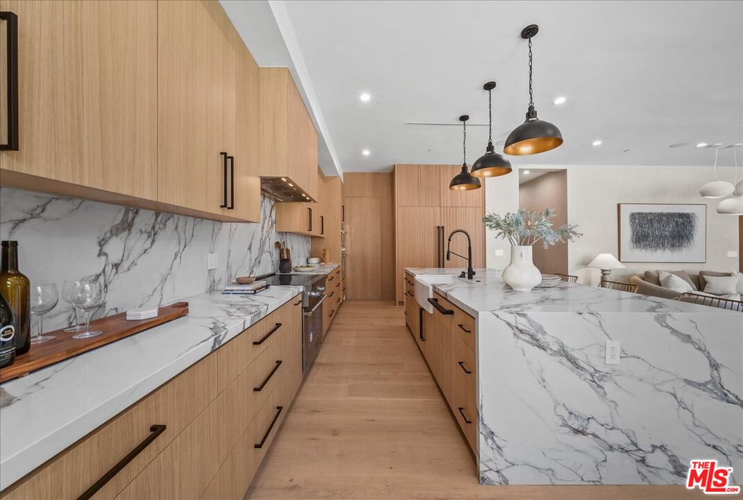 11317 Valley Spring Lane Studio City, CA 91602 - Photo 15 of 40 a large kitchen with stainless steel appliances lots of counter space and a sink