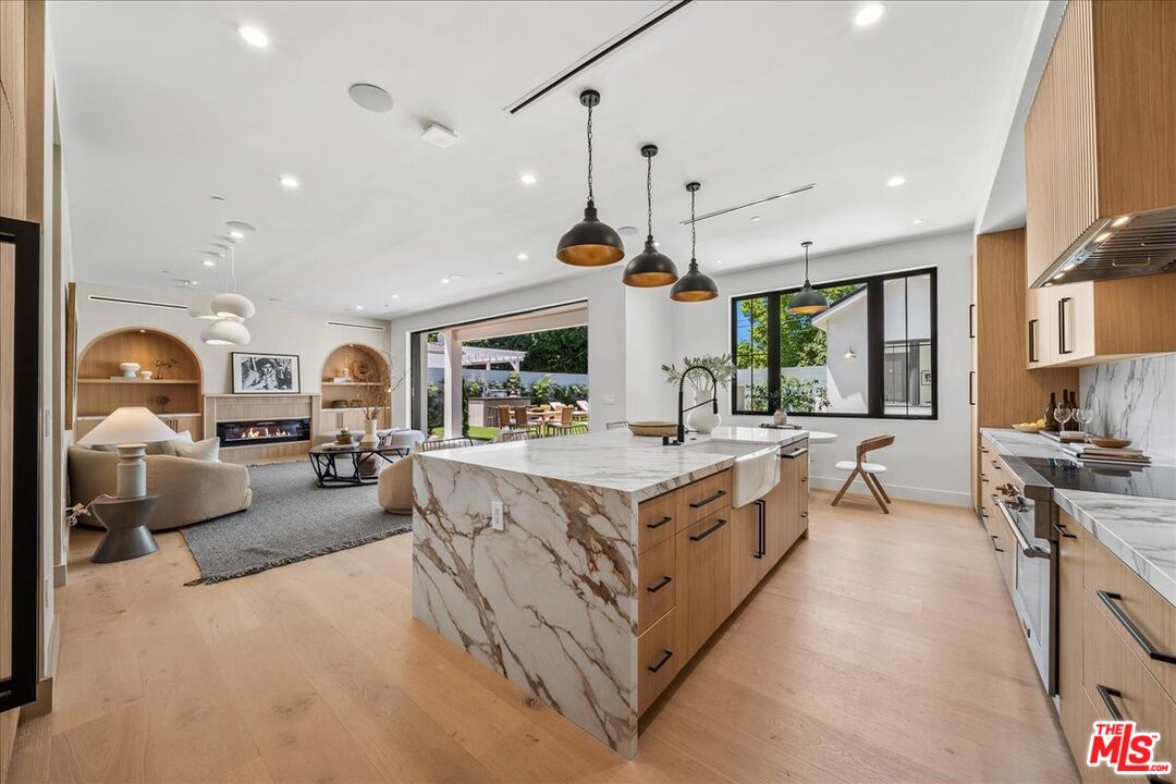 11317 Valley Spring Lane Studio City, CA 91602 - Photo 16 of 40 a large white kitchen with a large window