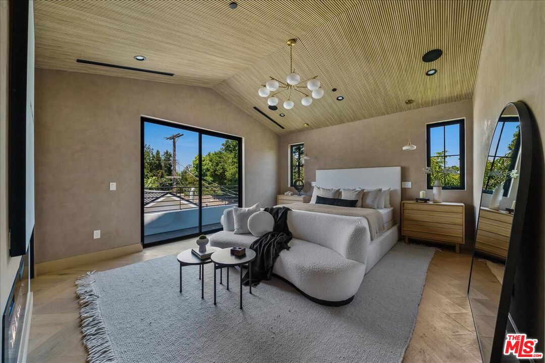 11317 Valley Spring Lane Studio City, CA 91602 - Photo 18 of 40 a living room with furniture and a chandelier