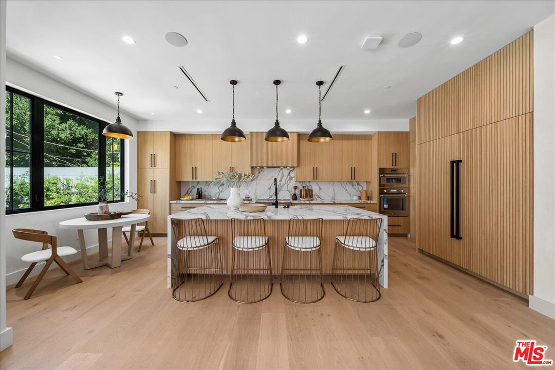 11317 Valley Spring Lane Studio City, CA 91602 - Photo 2 of 40 a large kitchen with a large window and stainless steel appliances