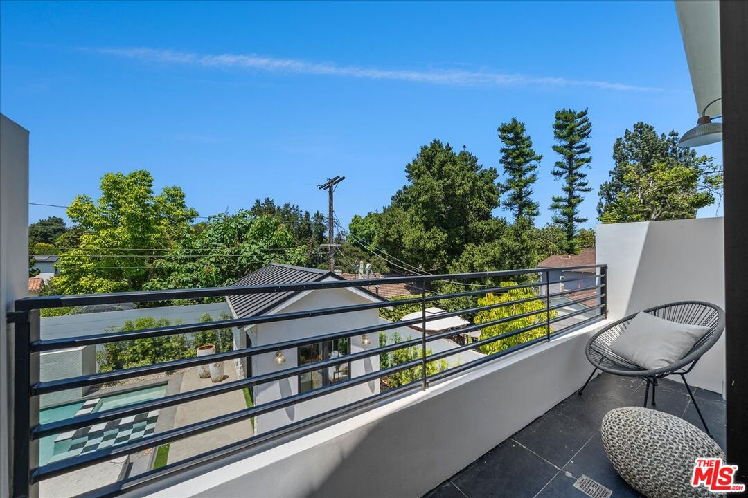 11317 Valley Spring Lane Studio City, CA 91602 - Photo 25 of 40 a view of a balcony with chairs and a potted plant