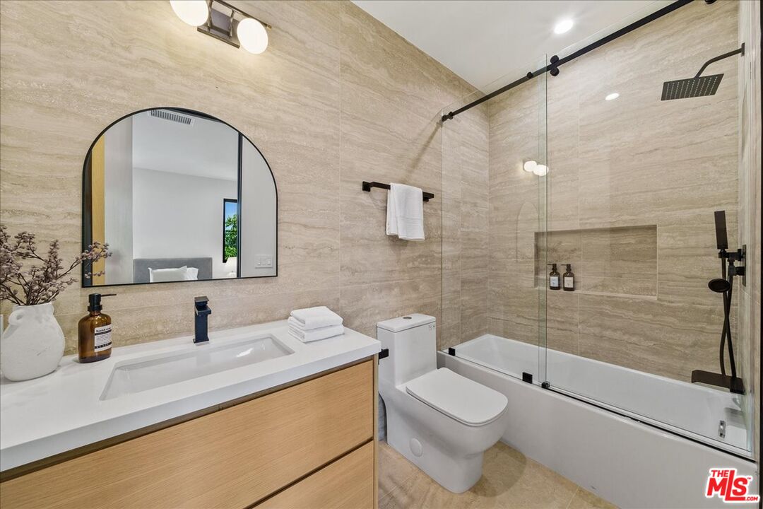 11317 Valley Spring Lane Studio City, CA 91602 - Photo 27 of 40 a bathroom with a toilet sink and shower