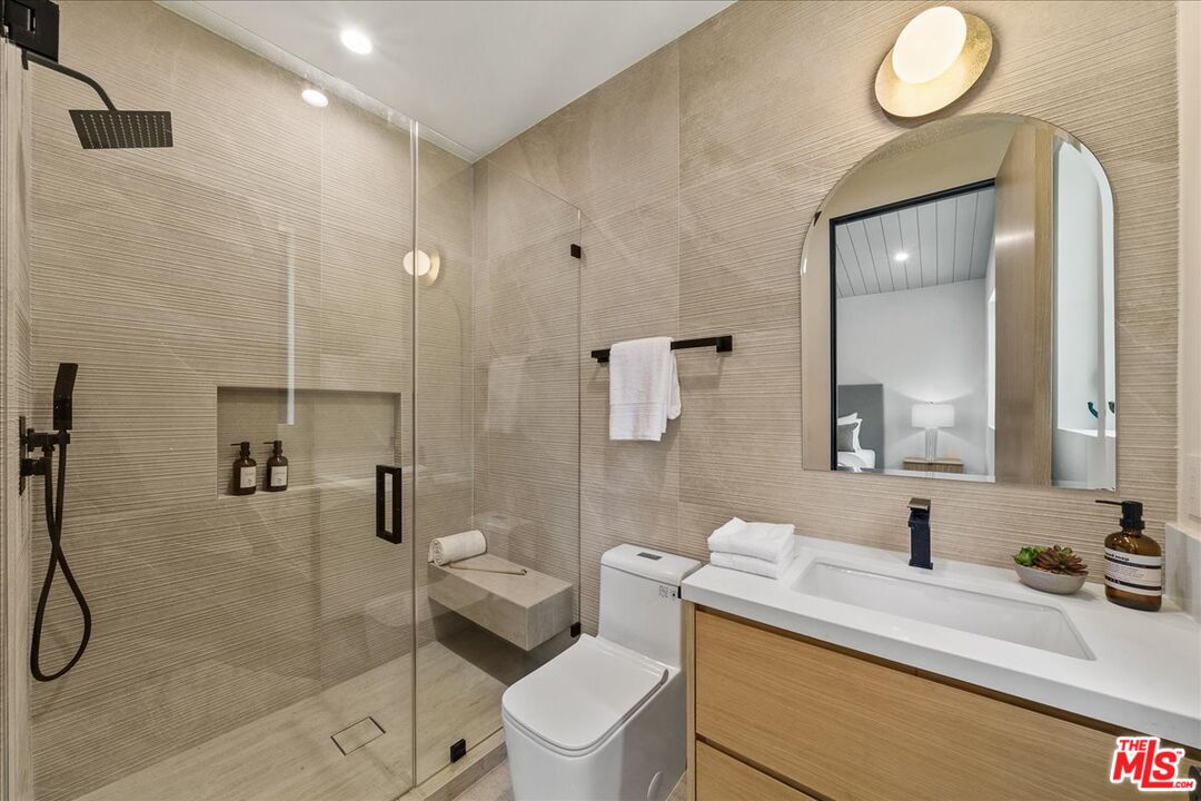 11317 Valley Spring Lane Studio City, CA 91602 - Photo 29 of 40 a bathroom with a sink a toilet and shower