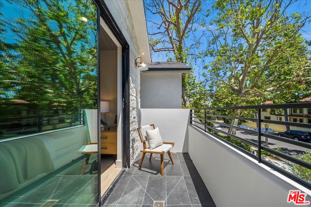 11317 Valley Spring Lane Studio City, CA 91602 - Photo 30 of 40 a porch with a bench next to a yard