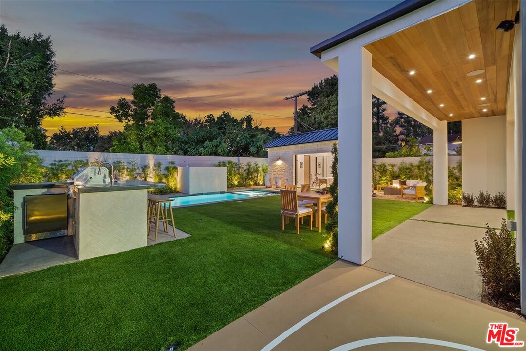 11317 Valley Spring Lane Studio City, CA 91602 - Photo 36 of 40 a view of backyard with swimming pool and outdoor seating