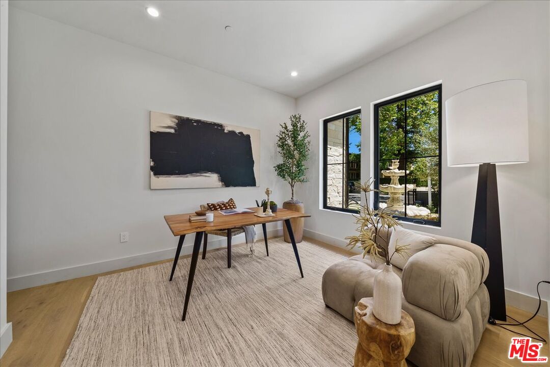 11317 Valley Spring Lane Studio City, CA 91602 - Photo 39 of 40 a living room with furniture a flat screen tv and a floor to ceiling window