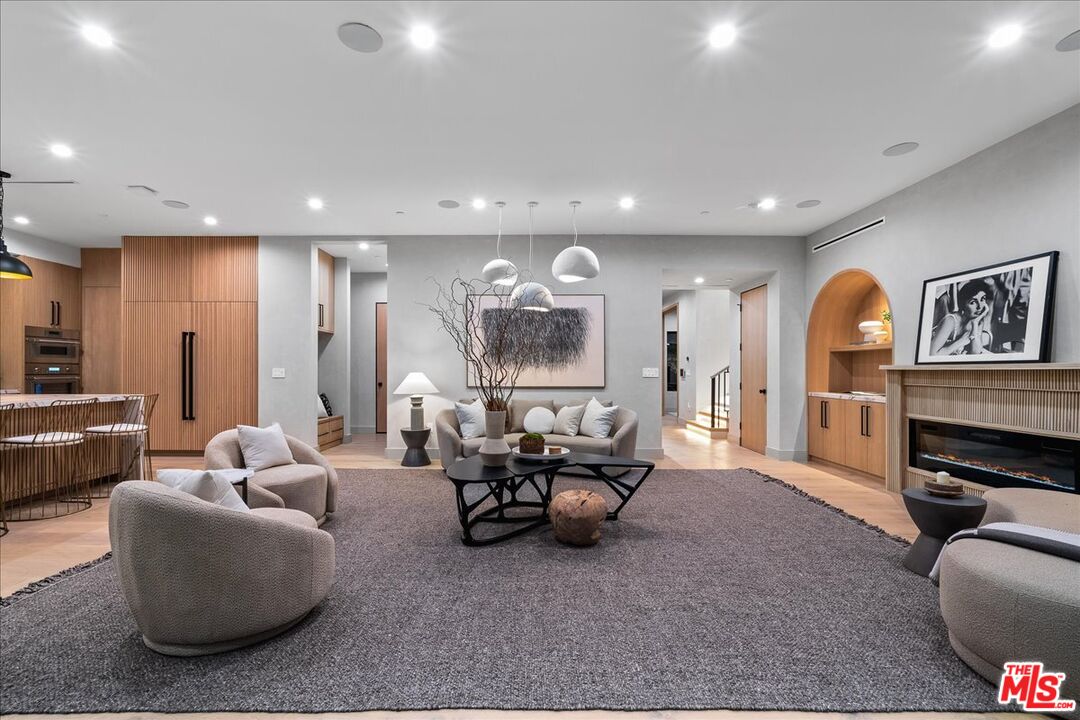 11317 Valley Spring Lane Studio City, CA 91602 - Photo 4 of 40 a living room with furniture flat screen tv and a large window