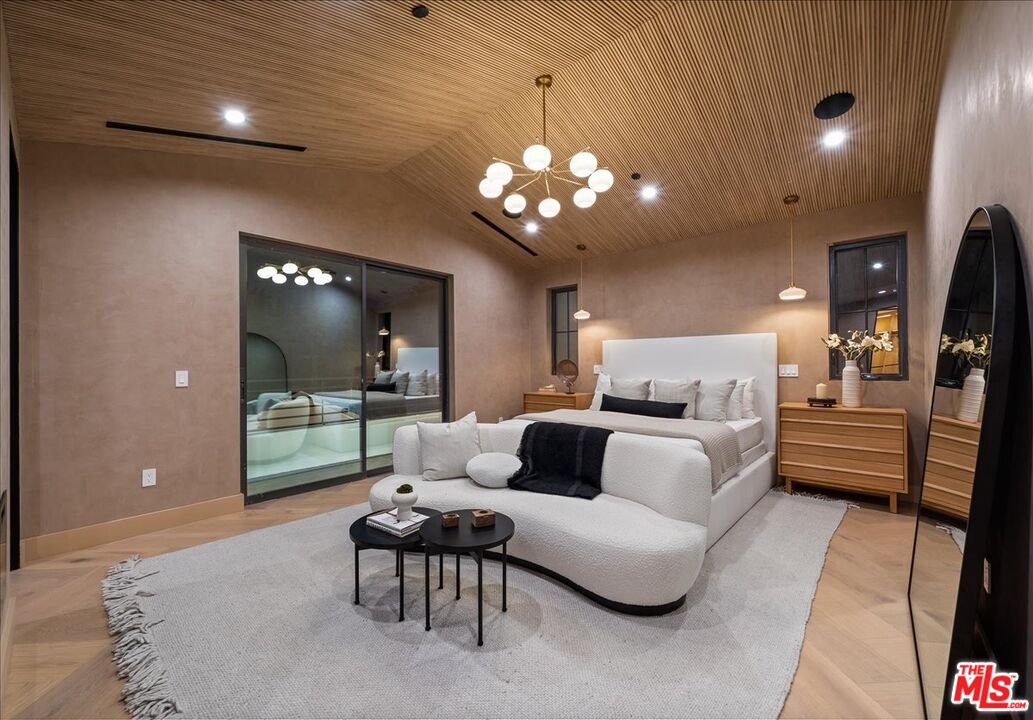 11317 Valley Spring Lane Studio City, CA 91602 - Photo 6 of 40 a living room with furniture and a chandelier