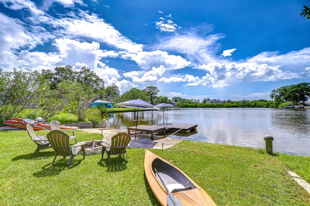 a view of a lake with a patio and a yard
