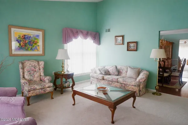 a living room with furniture and a lamp