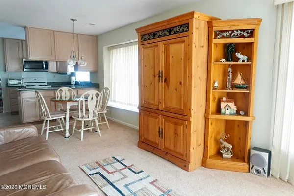 a dining room with furniture and a window