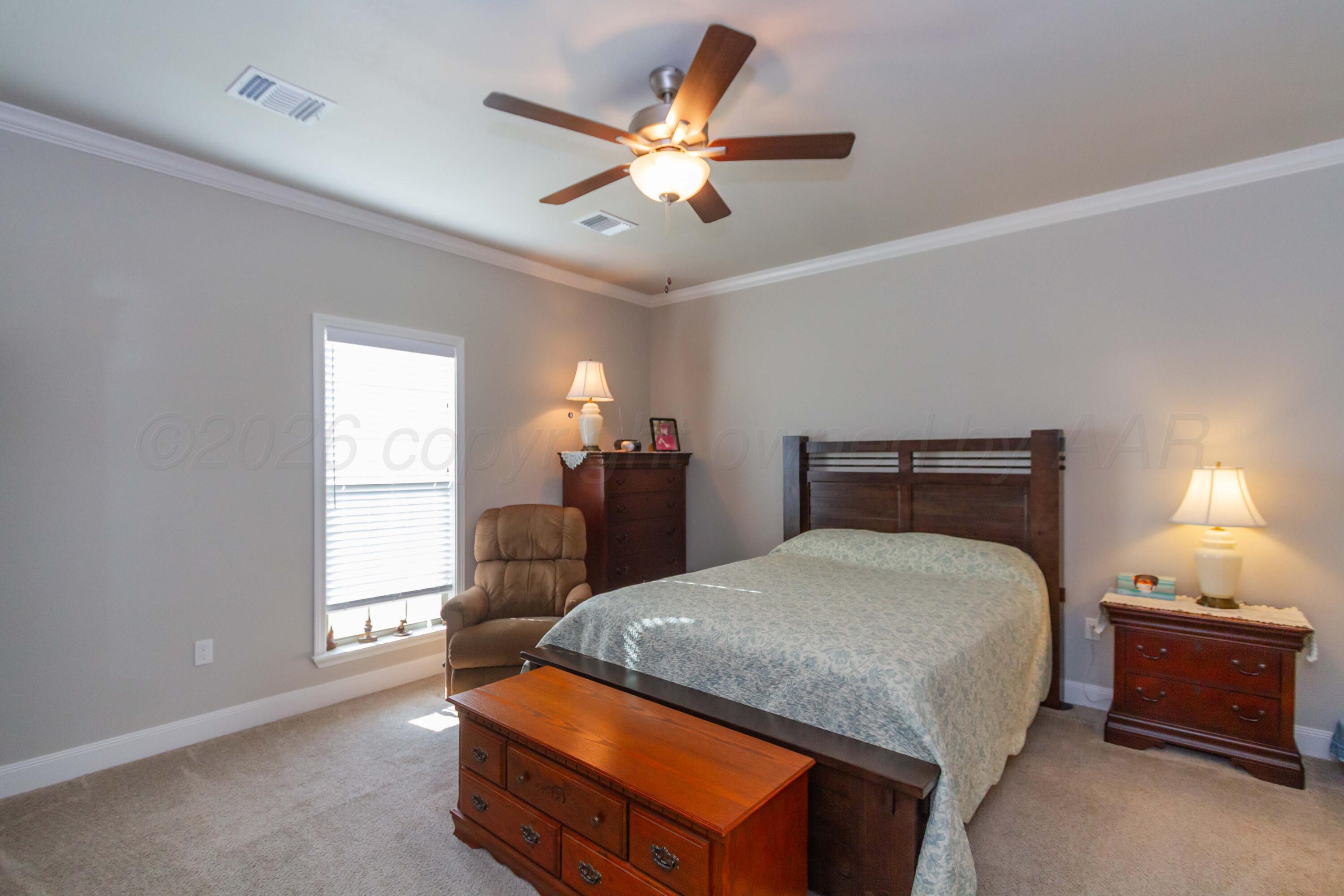 6909 Tatum Circle Amarillo, TX 79119 - Photo 11 of 33 a bedroom with a bed and window