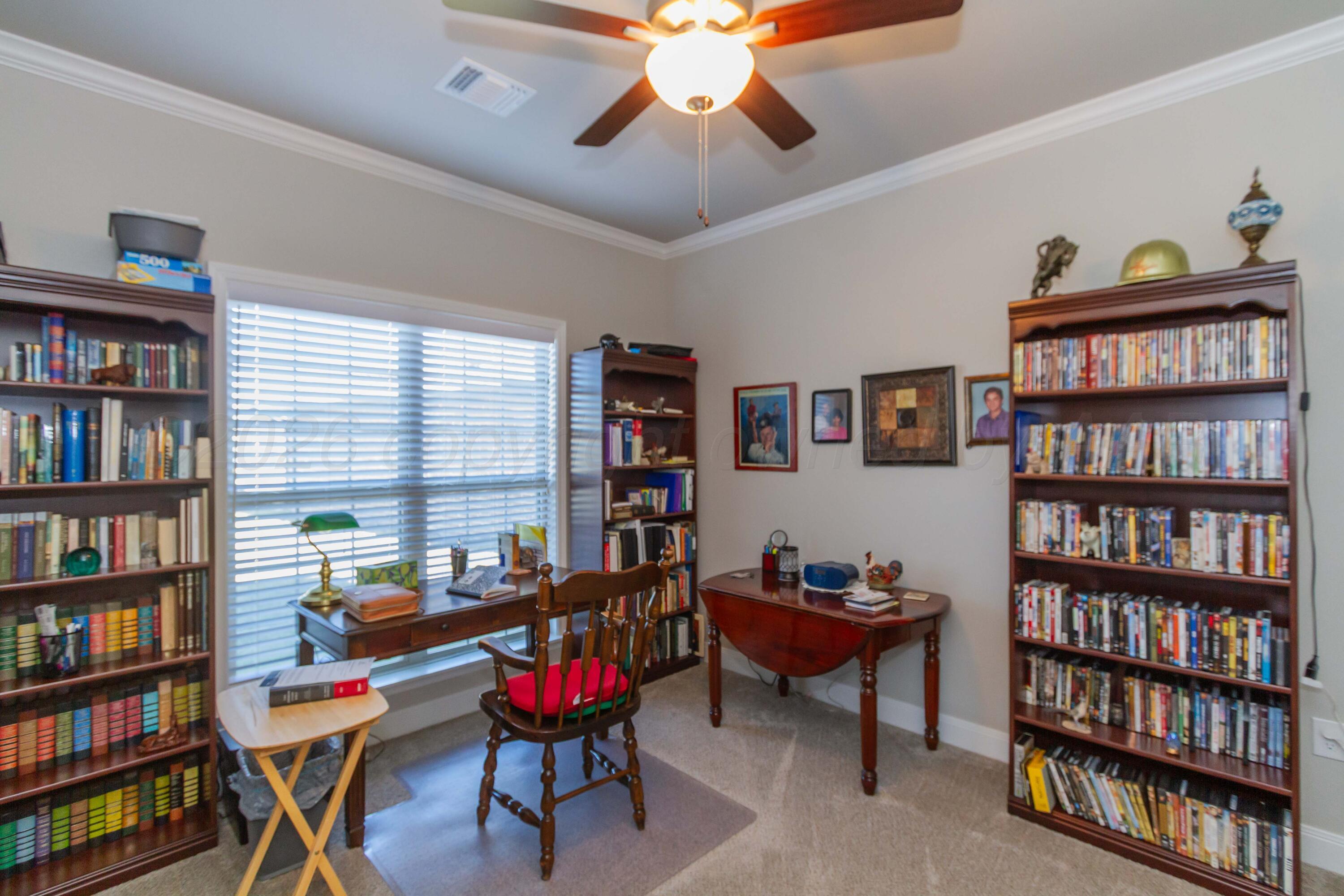 6909 Tatum Circle Amarillo, TX 79119 - Photo 21 of 33 a workspace with a book shelf and a book shelf