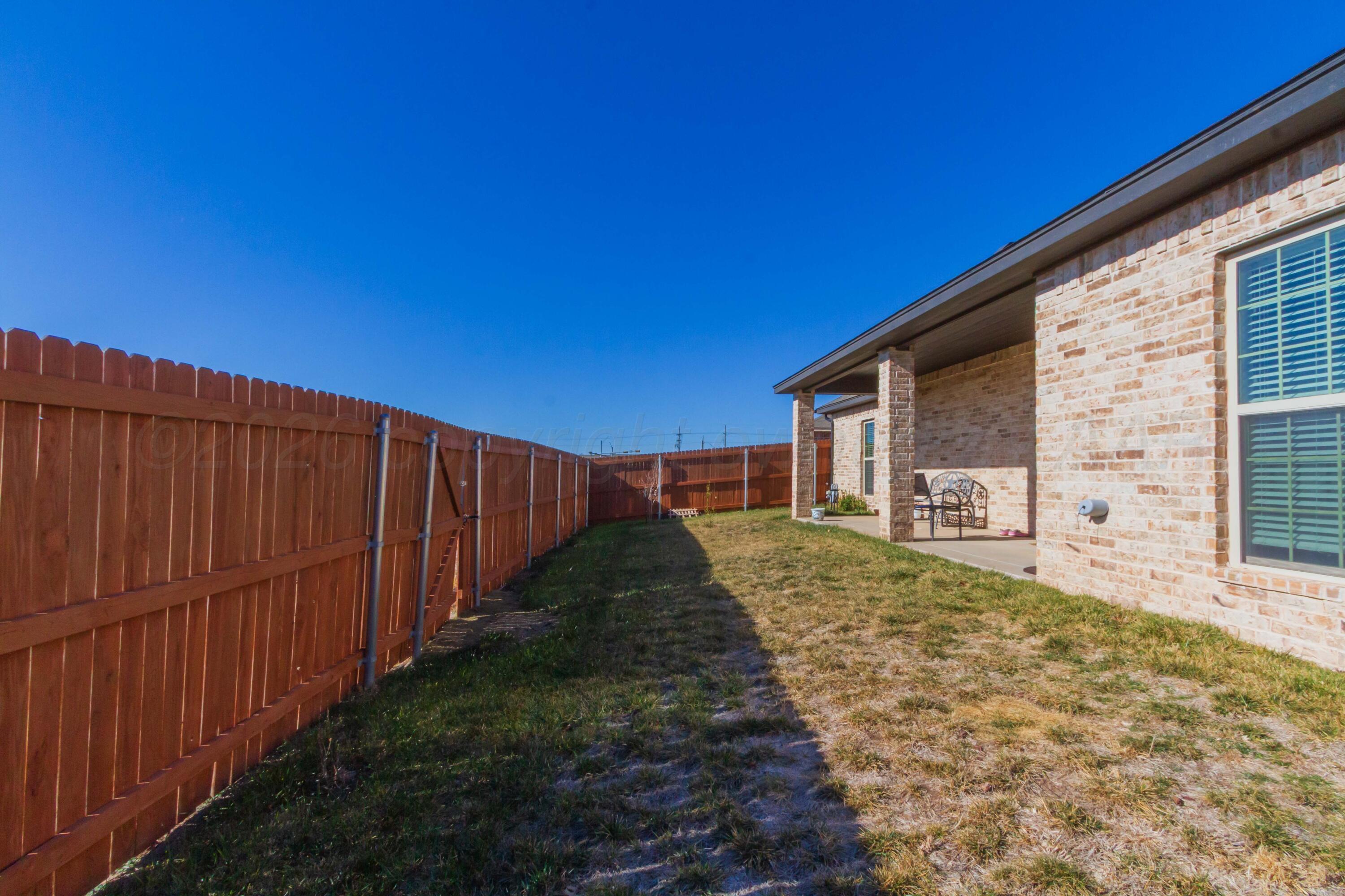 6909 Tatum Circle Amarillo, TX 79119 - Photo 29 of 33 a view of a house with backyard and wooden fence