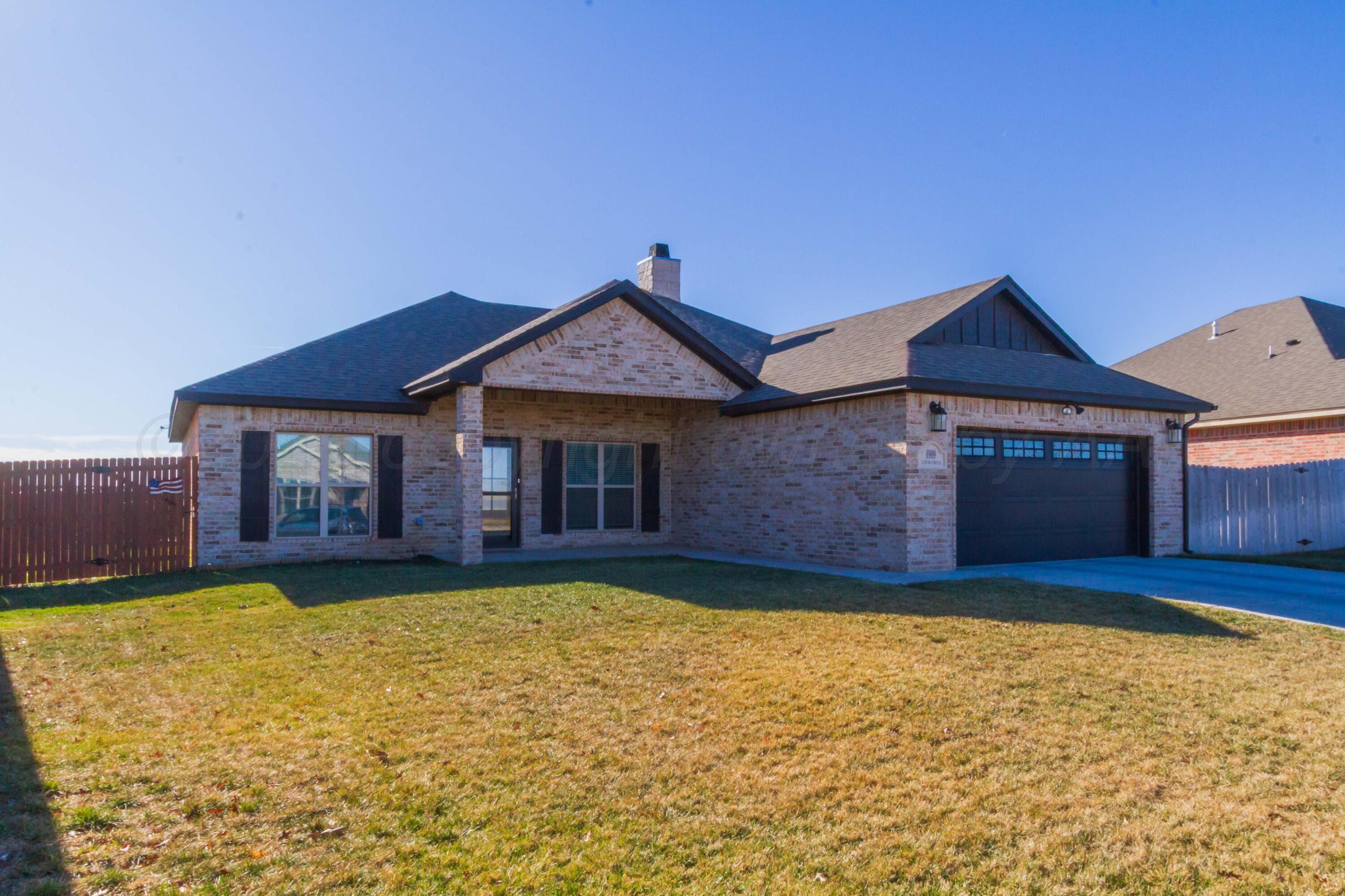 6909 Tatum Circle Amarillo, TX 79119 - Photo 33 of 33 a view of a house with a yard and large tree