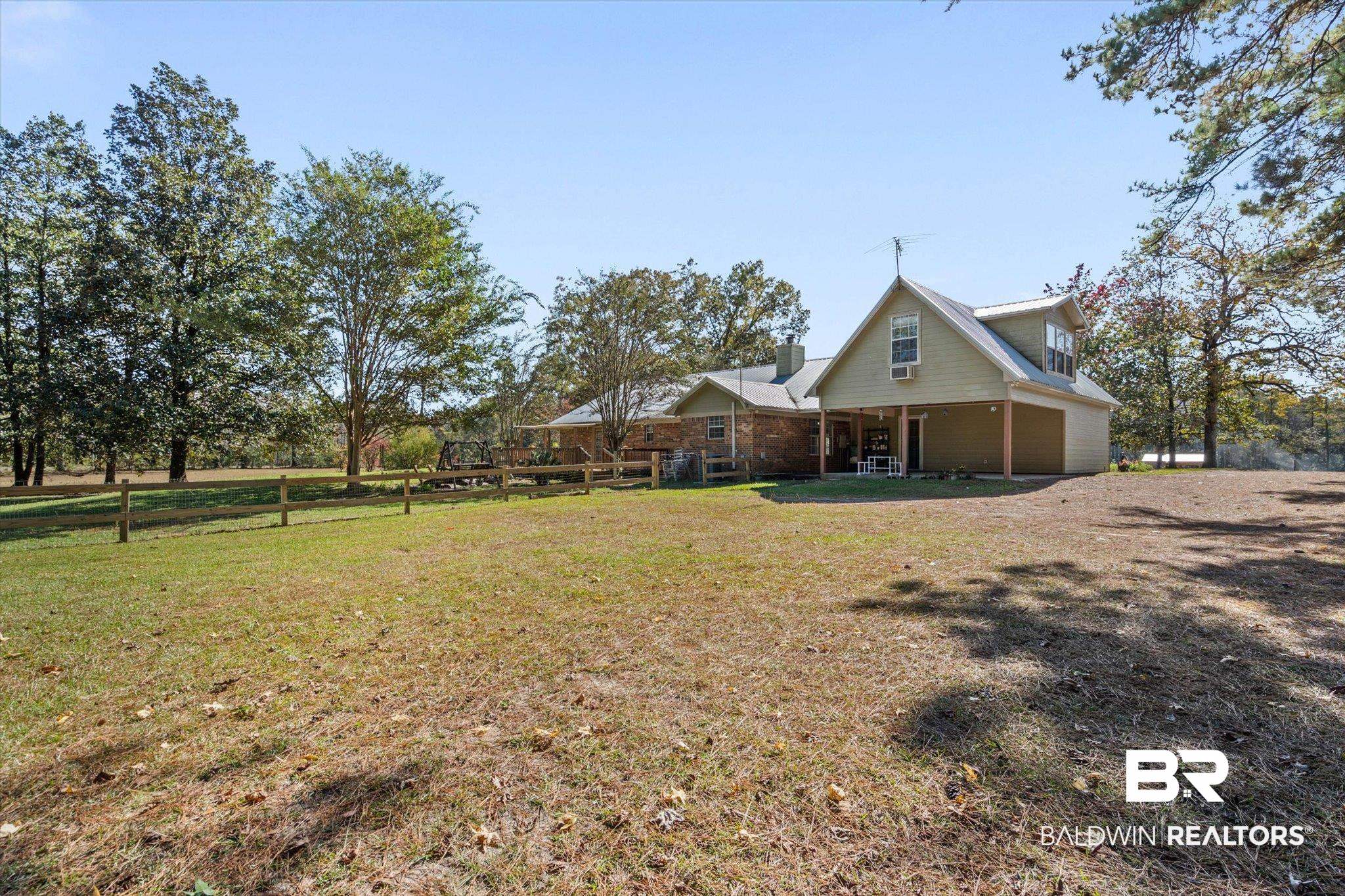 180 Creax Road Axis, AL 36505 - Photo 25 of 35 Rear view of property with a chimney and stone siding