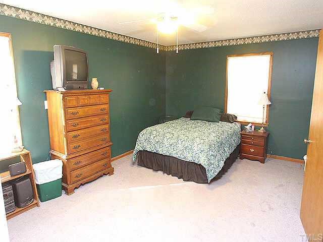 11309 John Allen Road Raleigh, NC 27614 - Photo 6 of 9 a bedroom with a bed and a dresser