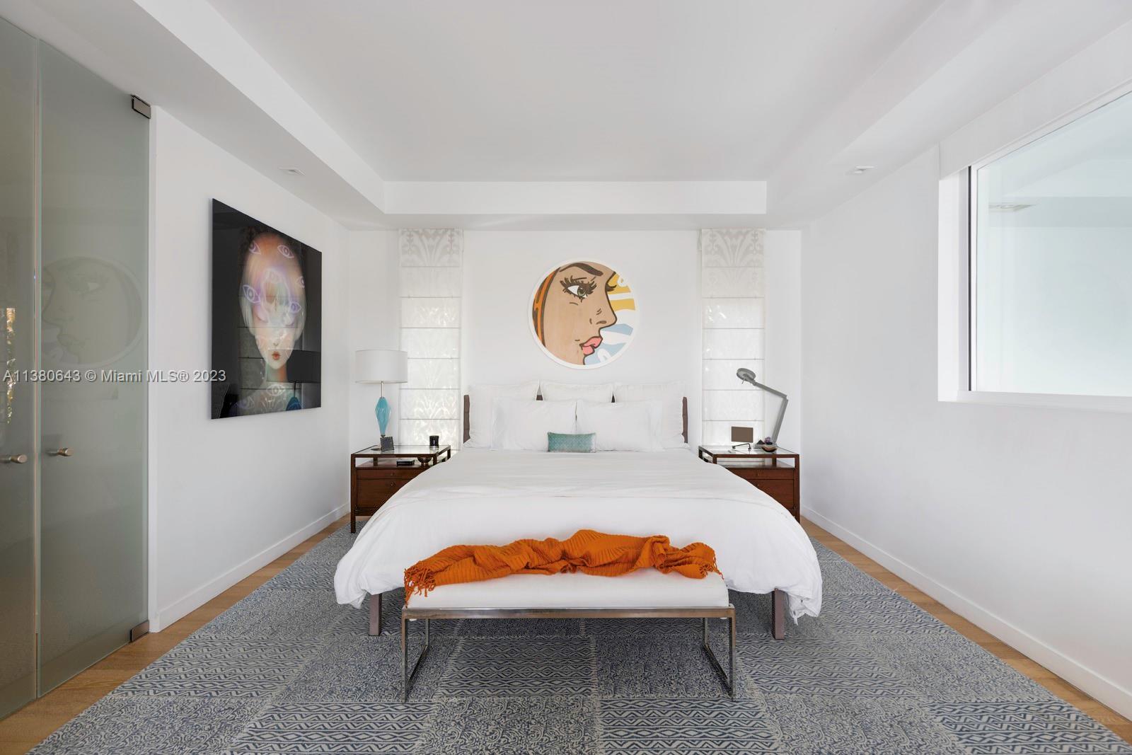 380 Woodcrest Road Key Biscayne, FL 33149 - Photo 19 of 31 a bed room with a bed mirror and wall painting