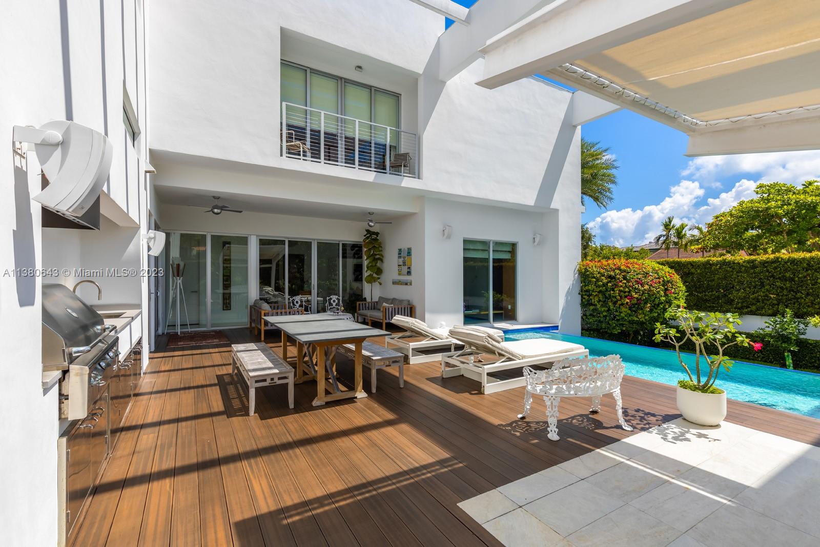 380 Woodcrest Road Key Biscayne, FL 33149 - Photo 24 of 31 a view of a house with backyard sitting area and garden