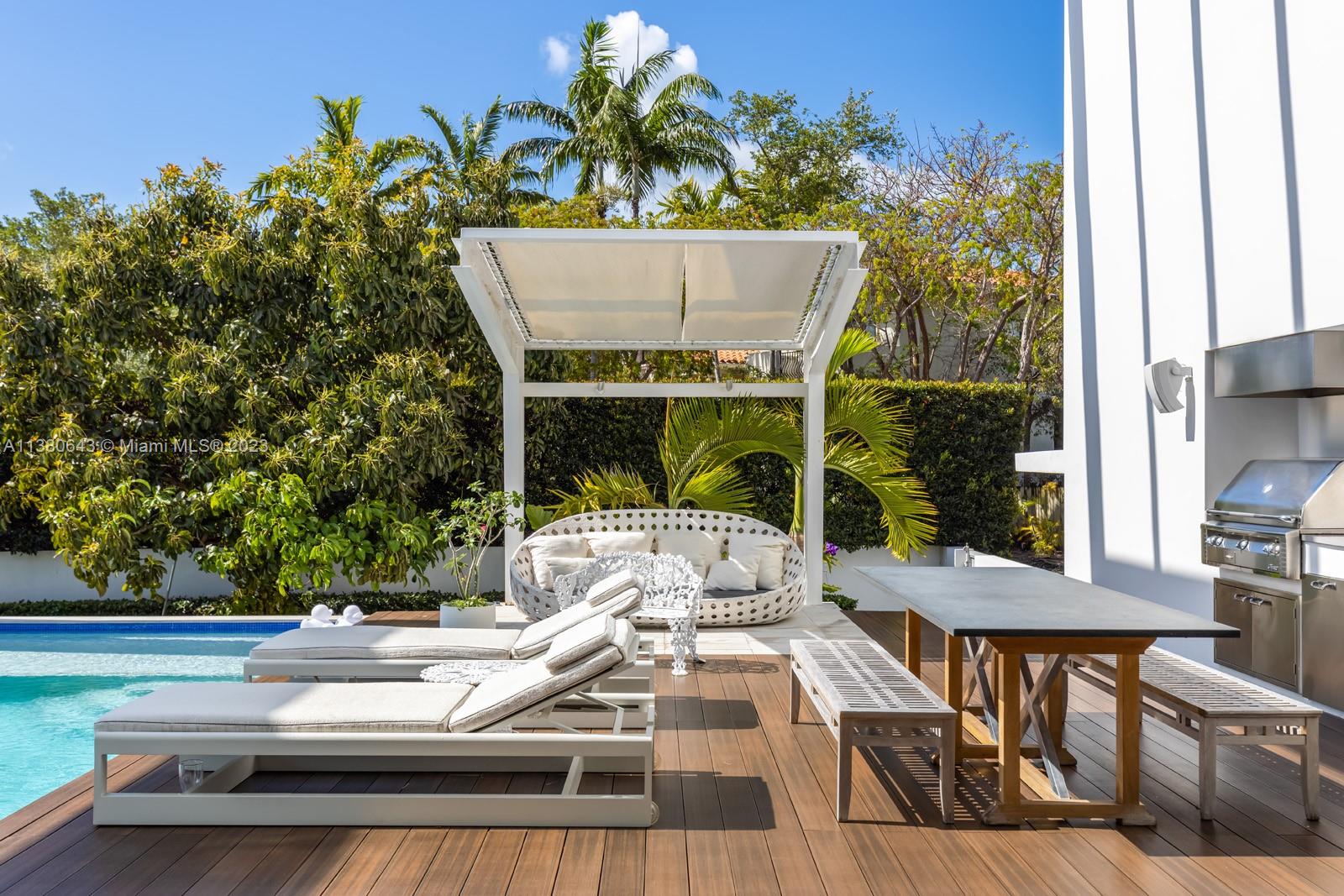 380 Woodcrest Road Key Biscayne, FL 33149 - Photo 26 of 31 a view of roof deck with table and chairs potted plants with wooden floor