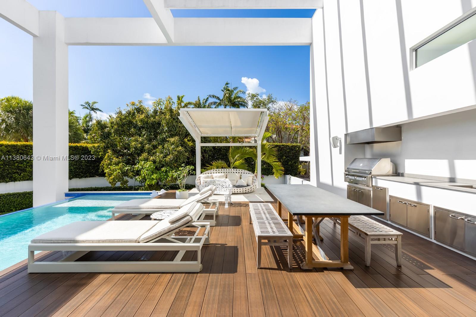 380 Woodcrest Road Key Biscayne, FL 33149 - Photo 27 of 31 a view of a balcony with couch and wooden floor