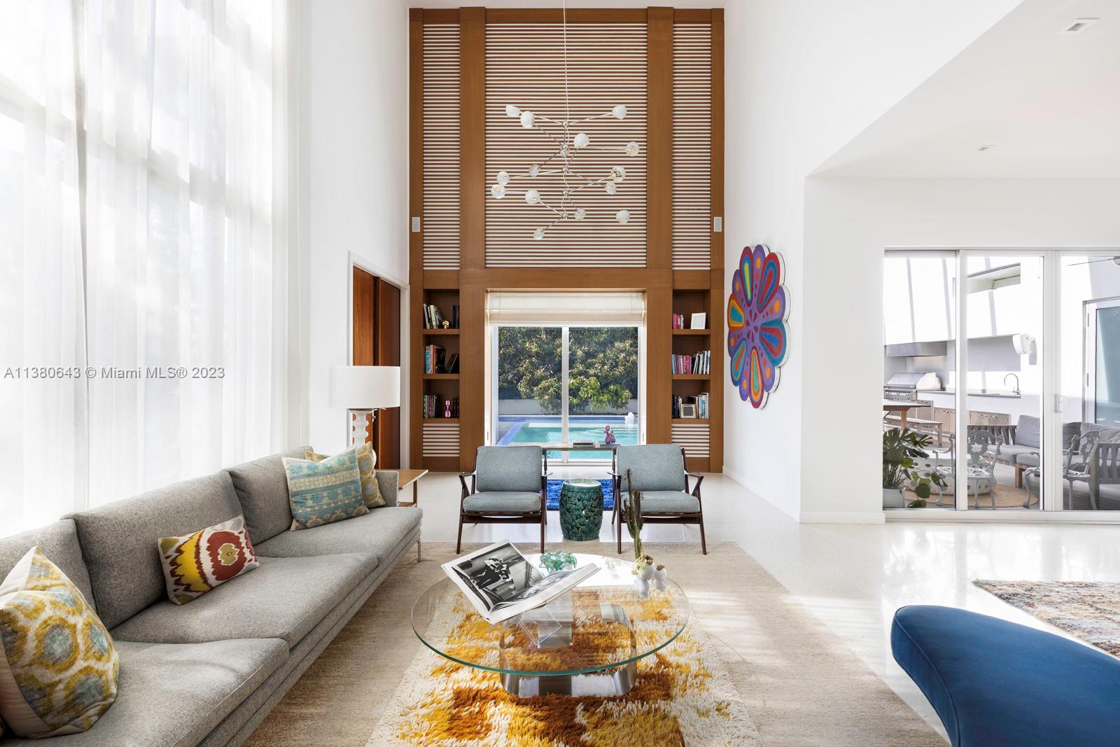 380 Woodcrest Road Key Biscayne, FL 33149 - Photo 4 of 31 a living room with furniture and floor to ceiling windows