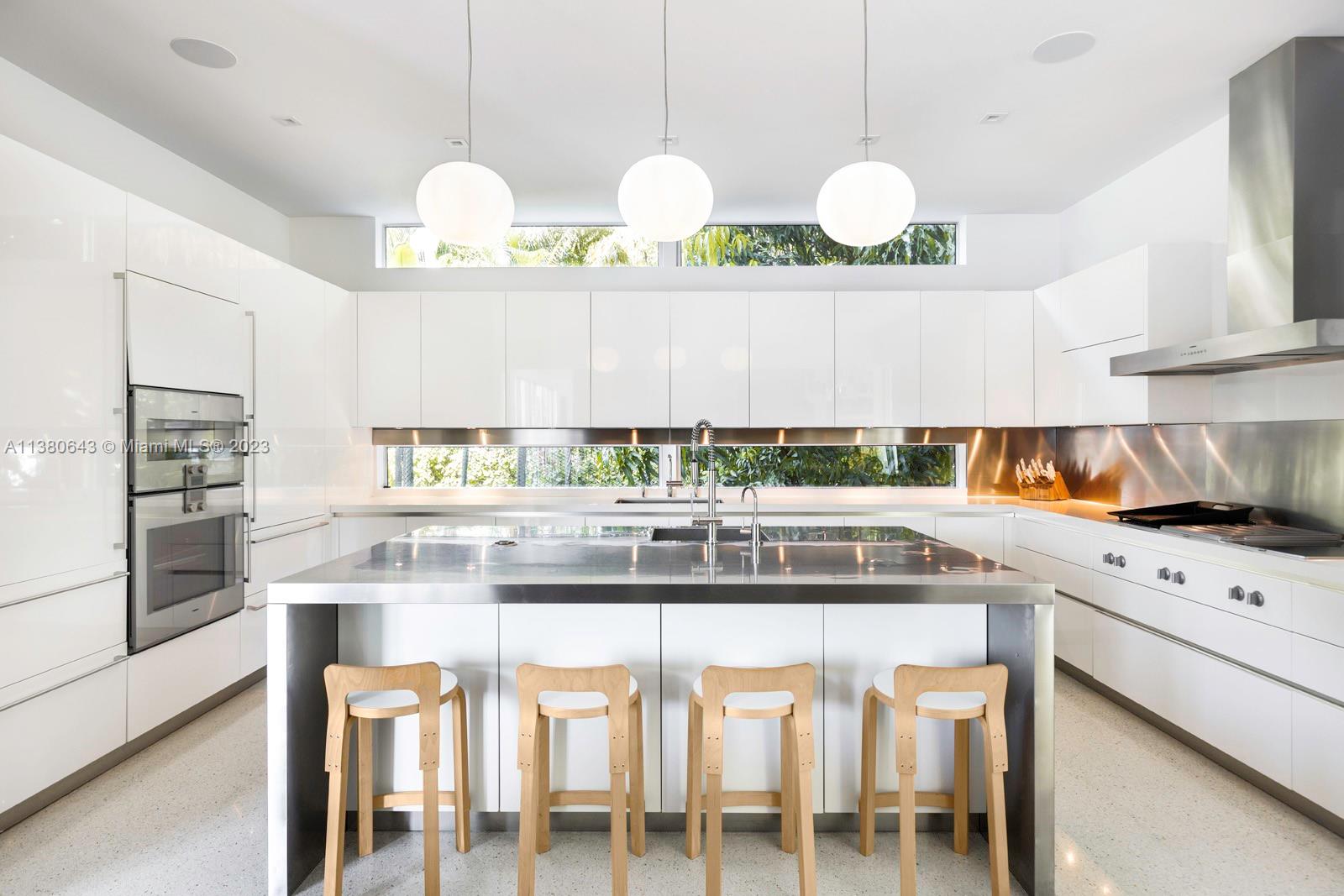 380 Woodcrest Road Key Biscayne, FL 33149 - Photo 10 of 31 a kitchen with a stove and a white cabinets