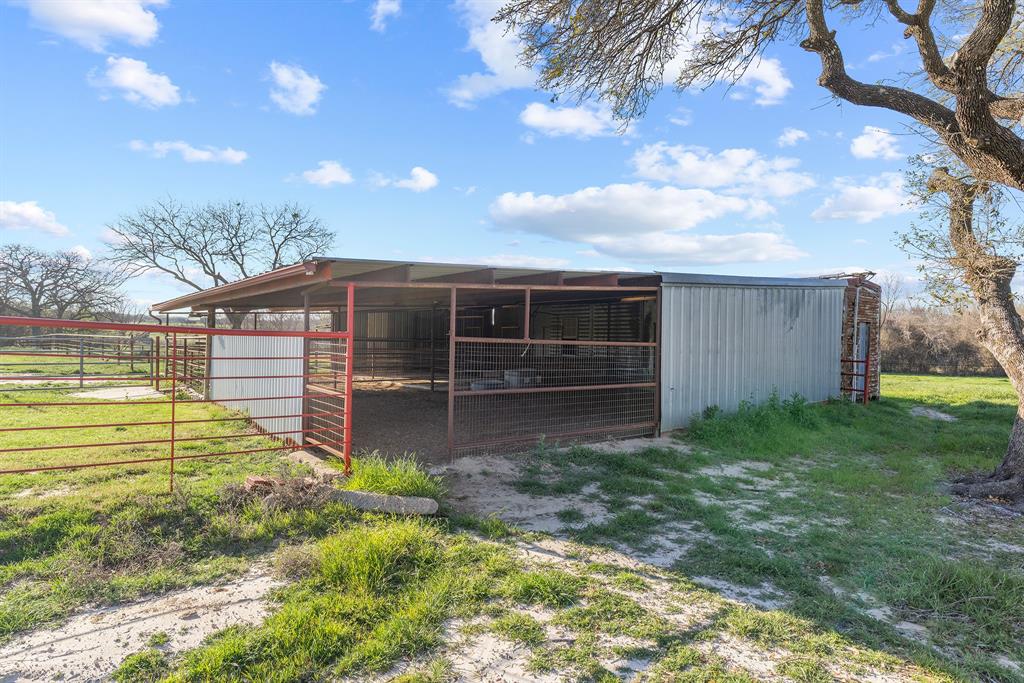 304 Scarlett Road Weatherford, TX 76087 - Photo 20 of 32 a view of a backyard with a large tree