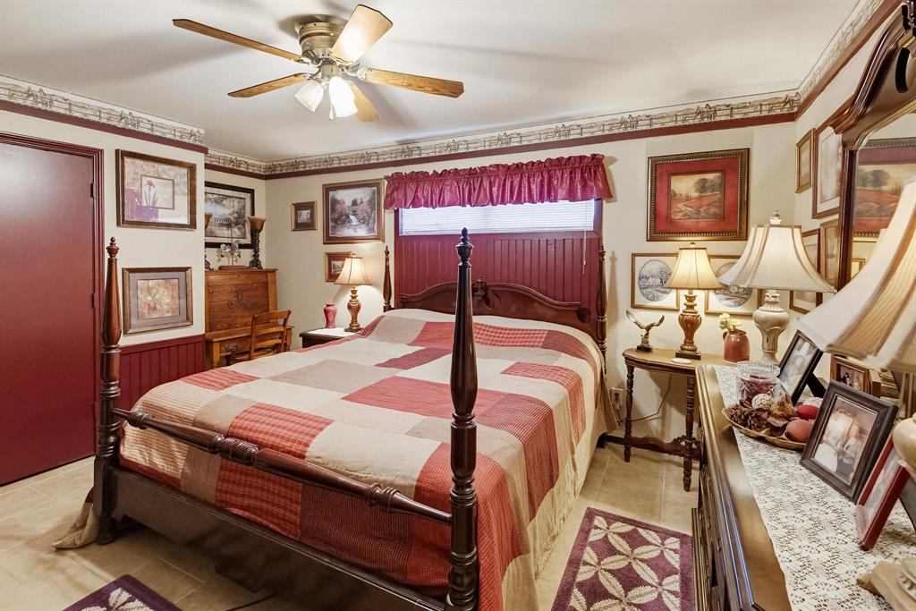 304 Scarlett Road Weatherford, TX 76087 - Photo 30 of 32 a bedroom with a bed and wooden floor