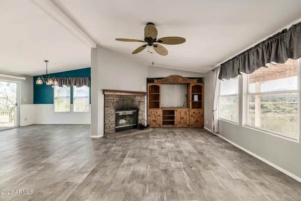 a view of a livingroom with a fireplace and a window
