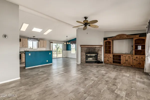 a view of a livingroom with a fireplace a window and a fireplace