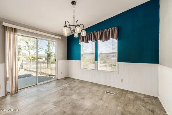 a view of a hallway with furniture and window
