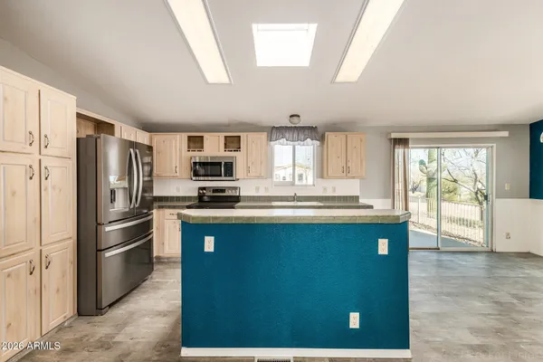 a kitchen with cabinets and refrigerator