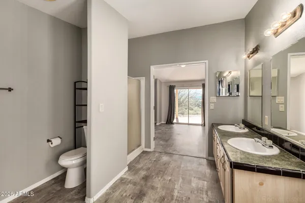 a spacious bathroom with a tub a mirror and a shower