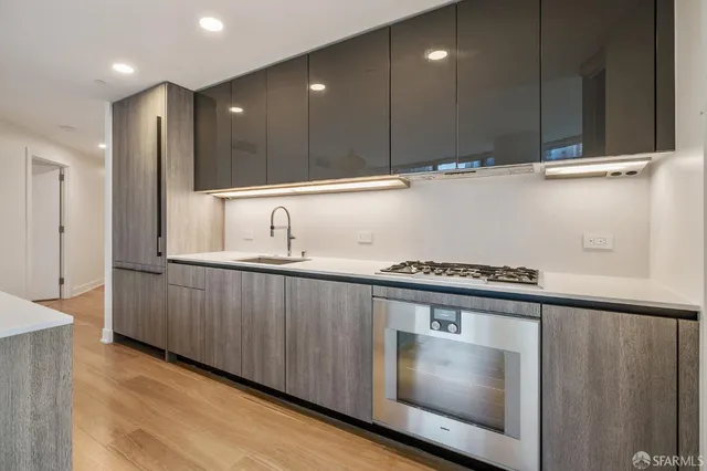 a kitchen with granite countertop a stove and a sink