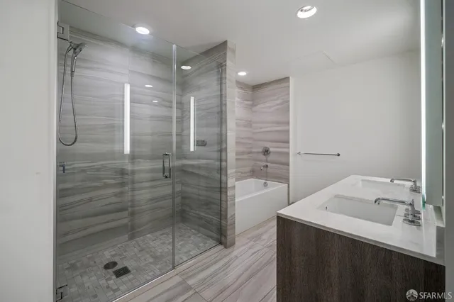 a bathroom with a shower mirror and a sink