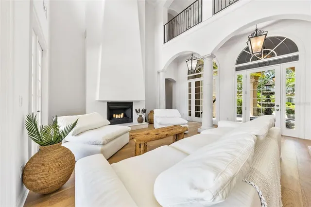 a living room with furniture fireplace and a large window