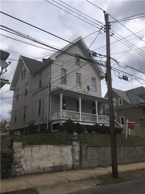 184 Pacific Street Bridgeport, CT 06604 - Photo 1 of 1 a front view of a house with a small yard