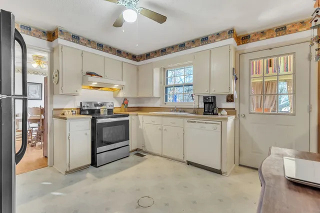 a kitchen with a sink cabinets and window