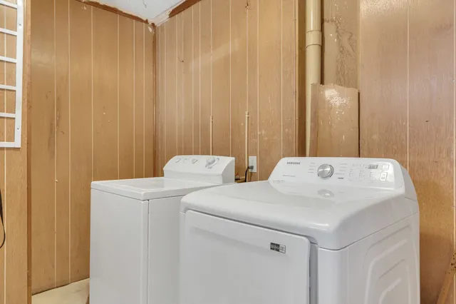 a view of a bathroom with a tub and shower