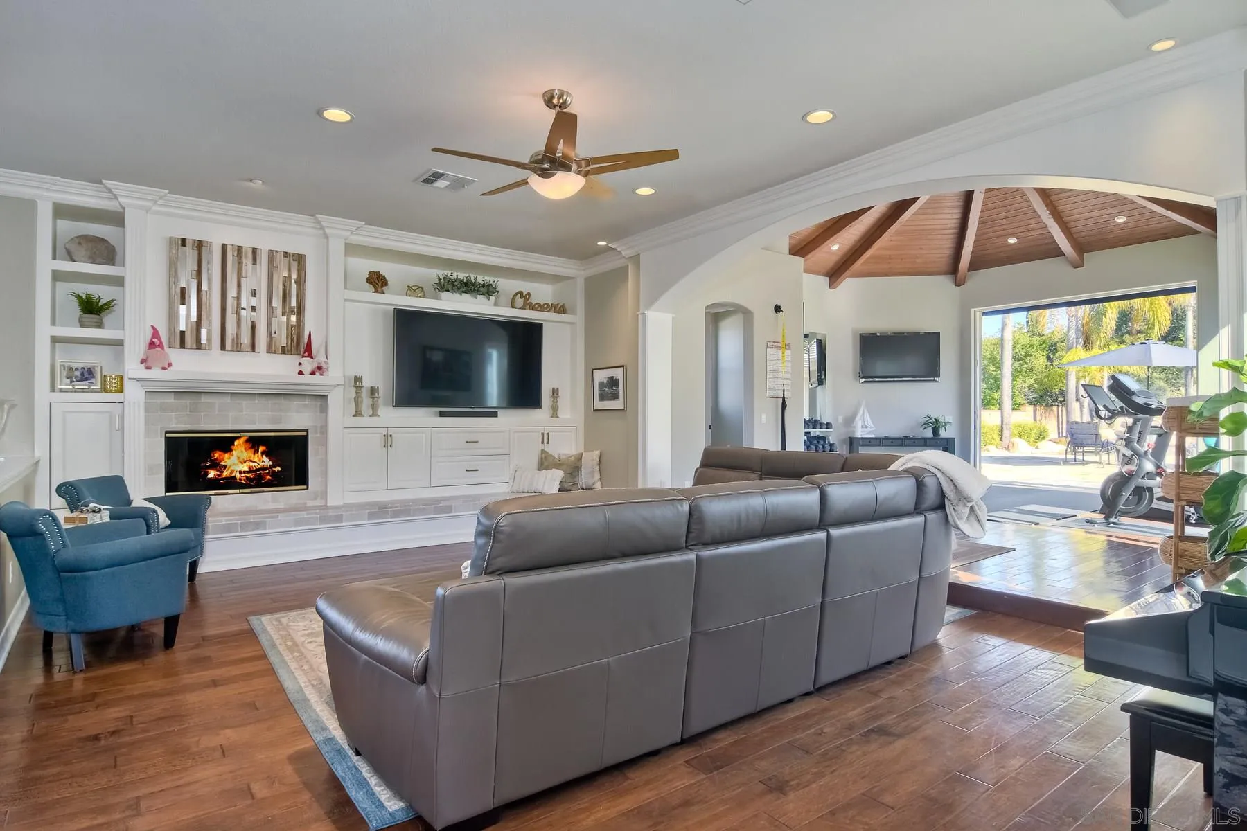 11739 Treadwell Drive Poway, CA 92064 - Photo 11 of 46 a living room with furniture a fireplace and a flat screen tv